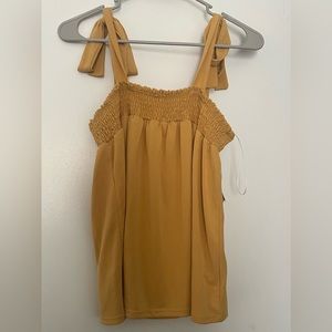 NWT. Mustard tank top, tie straps. Size medium.